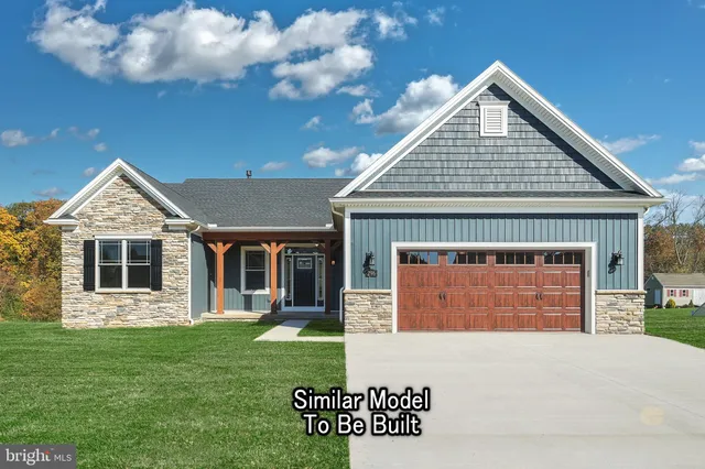a view of a house with a yard and a porch