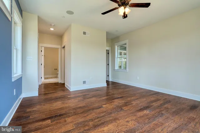 a view of walk in closet with wooden floor