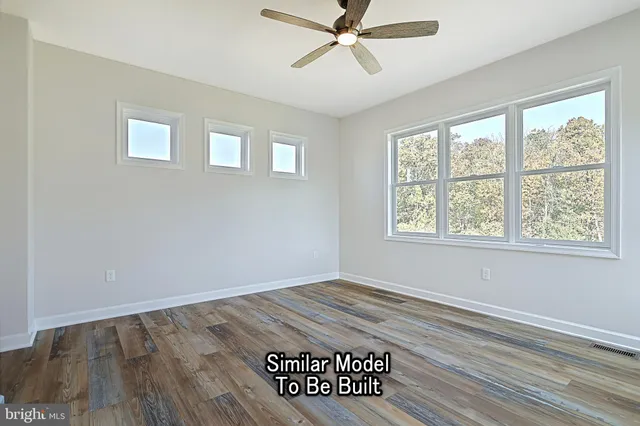 a view of a hallway with a window and wooden floor