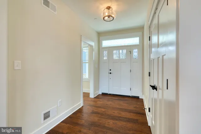 a view of kitchen with granite countertop cabinets and wooden floor