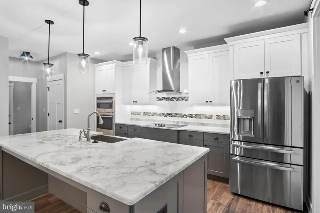 a kitchen with kitchen island granite countertop a sink stainless steel appliances and window