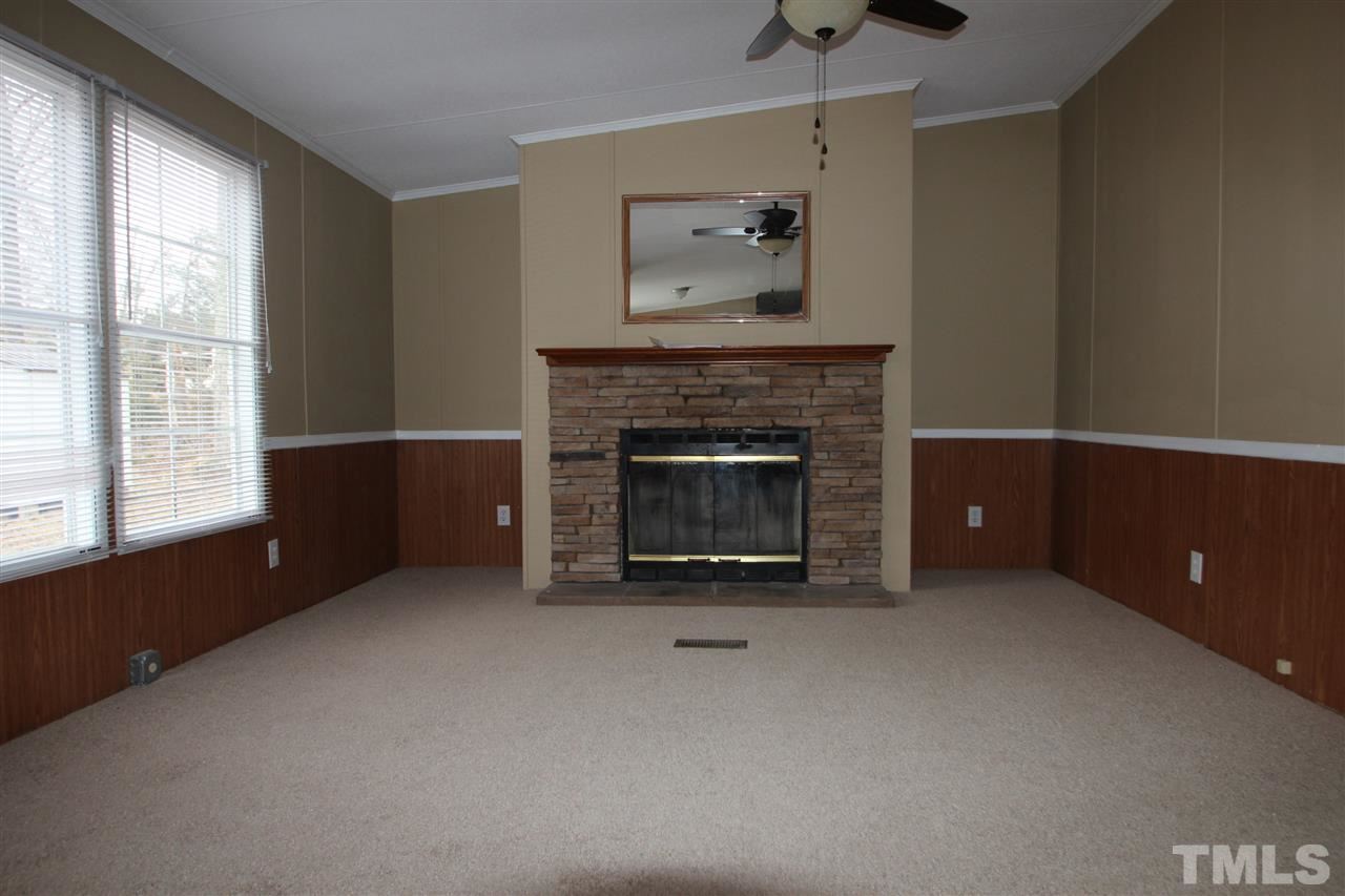465 Melton Road Roxboro, NC 27574 - Photo 2 of 11 a living room with furniture and a fireplace