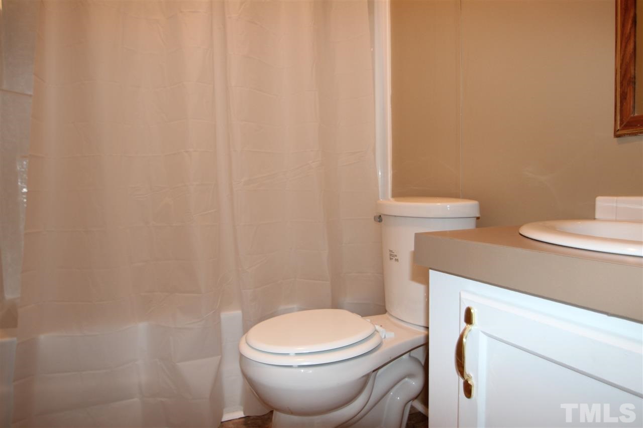 465 Melton Road Roxboro, NC 27574 - Photo 11 of 11 a white toilet sitting next to a white sink