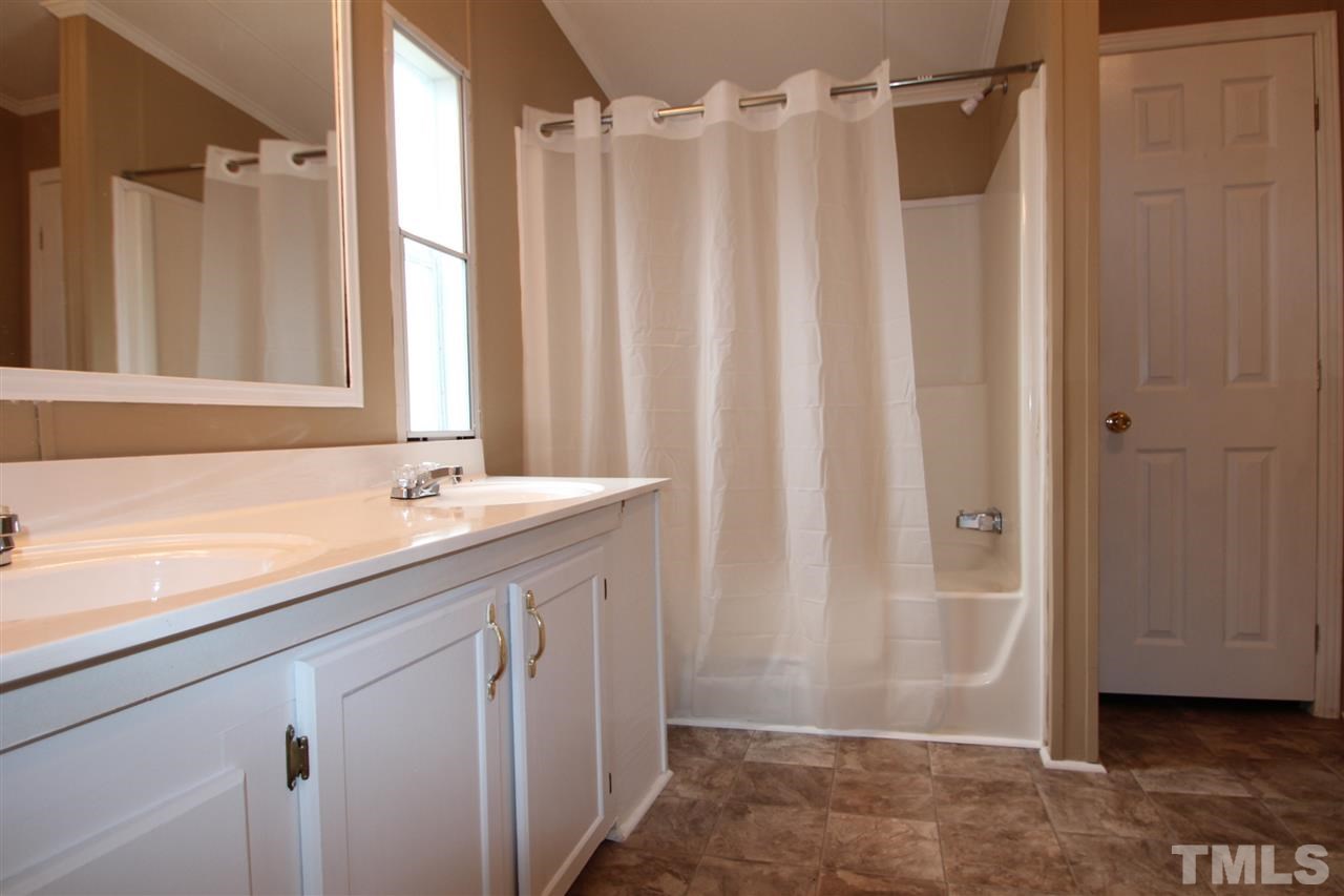 465 Melton Road Roxboro, NC 27574 - Photo 8 of 11 a bathroom with a shower and a sink
