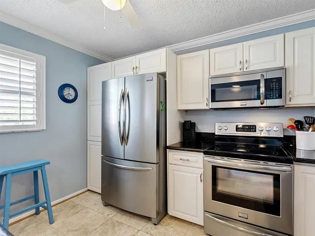 a kitchen with stainless steel appliances a sink and a granite counter tops