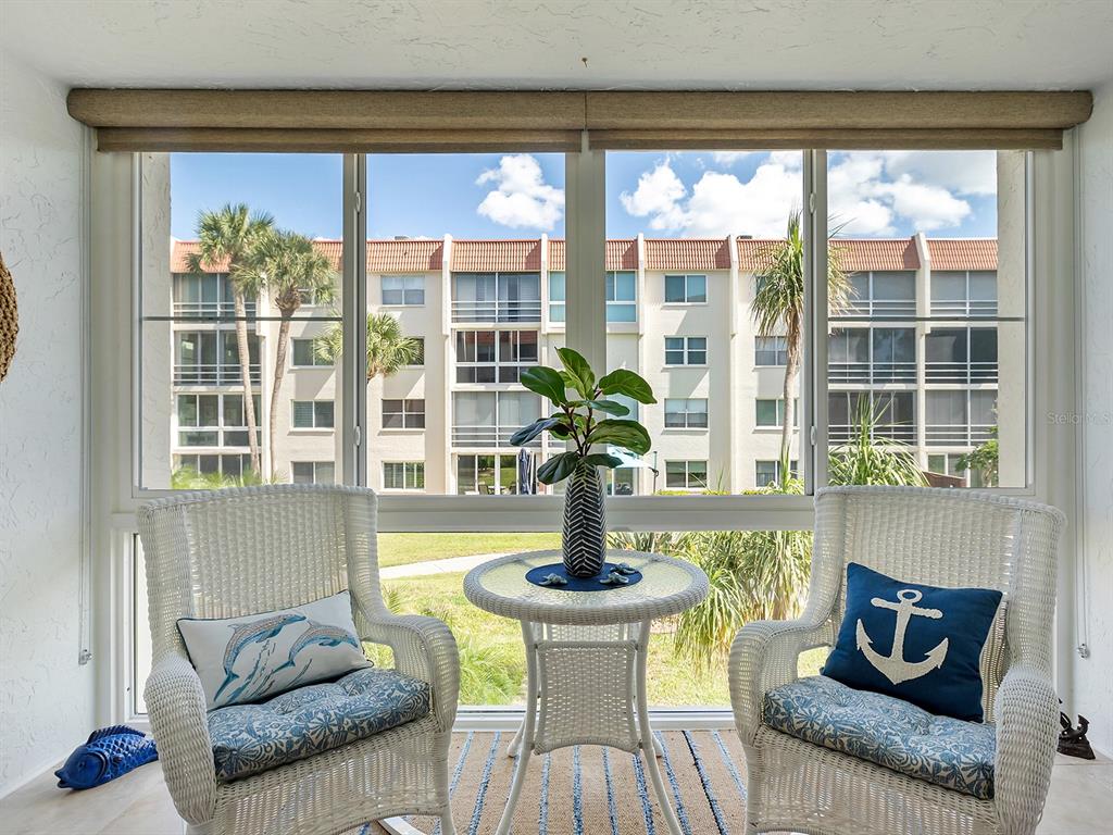 230 Santa Maria Street, Unit 234 Venice, FL 34285 - Photo 16 of 60 a living room with furniture and a large window