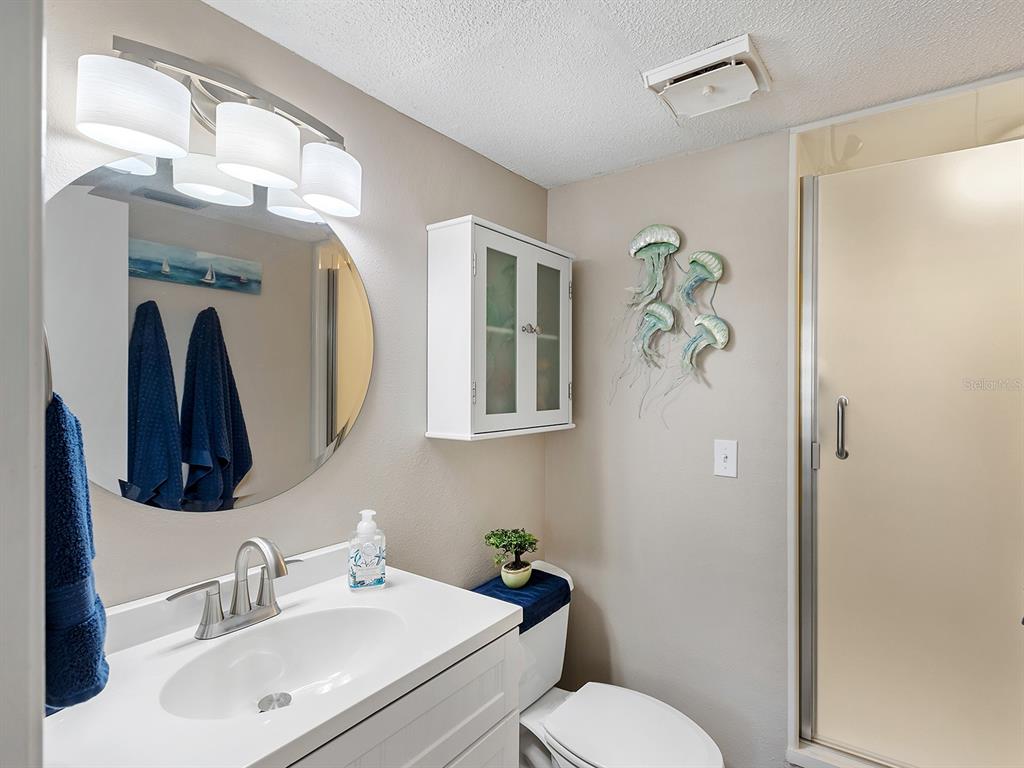 230 Santa Maria Street, Unit 234 Venice, FL 34285 - Photo 25 of 60 a bathroom with a toilet sink and mirror