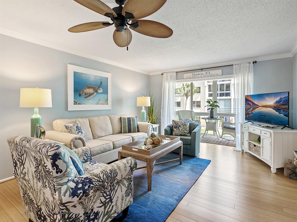 230 Santa Maria Street, Unit 234 Venice, FL 34285 - Photo 4 of 60 a living room with furniture flat screen tv and wooden floor