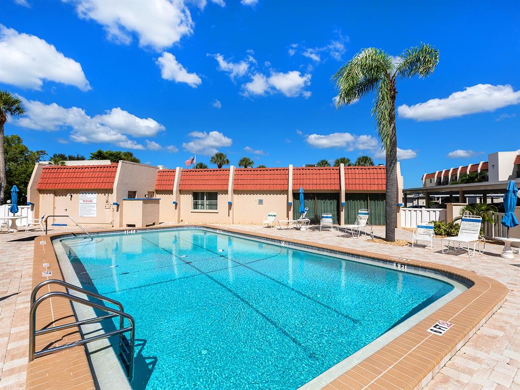 230 Santa Maria Street, Unit 234 Venice, FL 34285 - Photo 43 of 60 a view of a swimming pool with a chair and tables