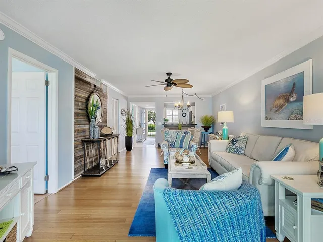 a view of a dining room with furniture a chandelier and wooden floor