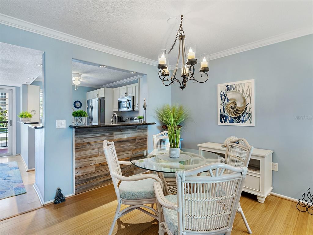 230 Santa Maria Street, Unit 234 Venice, FL 34285 - Photo 9 of 60 a view of a dining room with furniture and wooden floor
