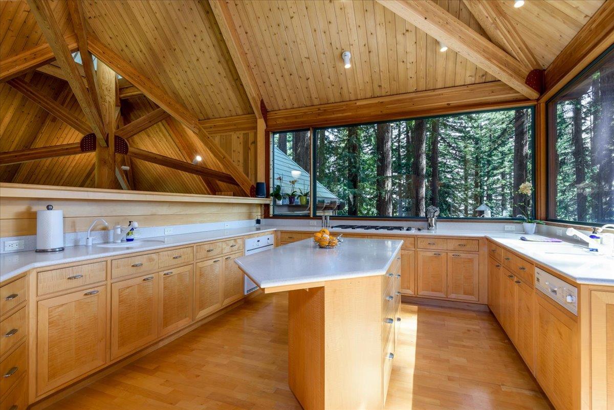9 Summit Road Woodside, CA 94062 - Photo 7 of 38 a kitchen with stainless steel appliances wooden cabinets a sink and a large window