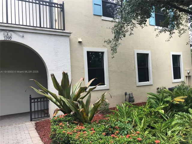 a potted plant sitting in front of a house