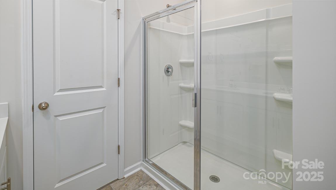 269 Shorthorn Road Fletcher, NC 28732 - Photo 12 of 23 a bathroom with a glass shower door