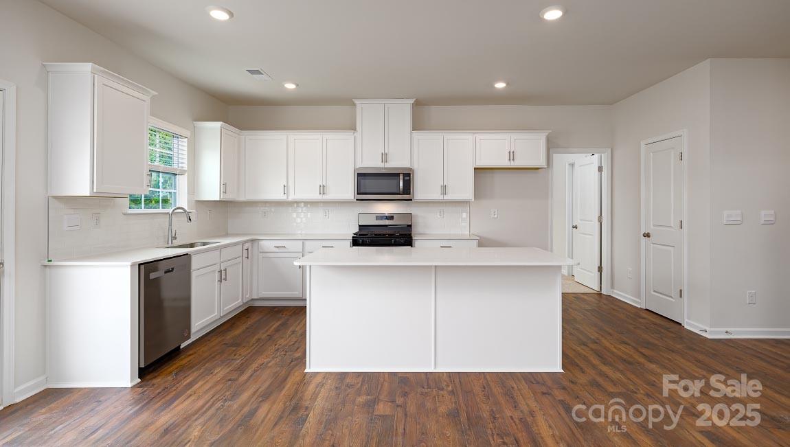 269 Shorthorn Road Fletcher, NC 28732 - Photo 3 of 23 a kitchen with a hard wood floor white cabinets and white appliances