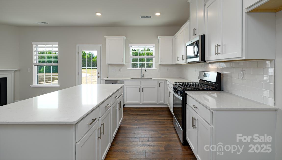 269 Shorthorn Road Fletcher, NC 28732 - Photo 4 of 23 a kitchen with kitchen island granite countertop a sink a counter space appliances and a window