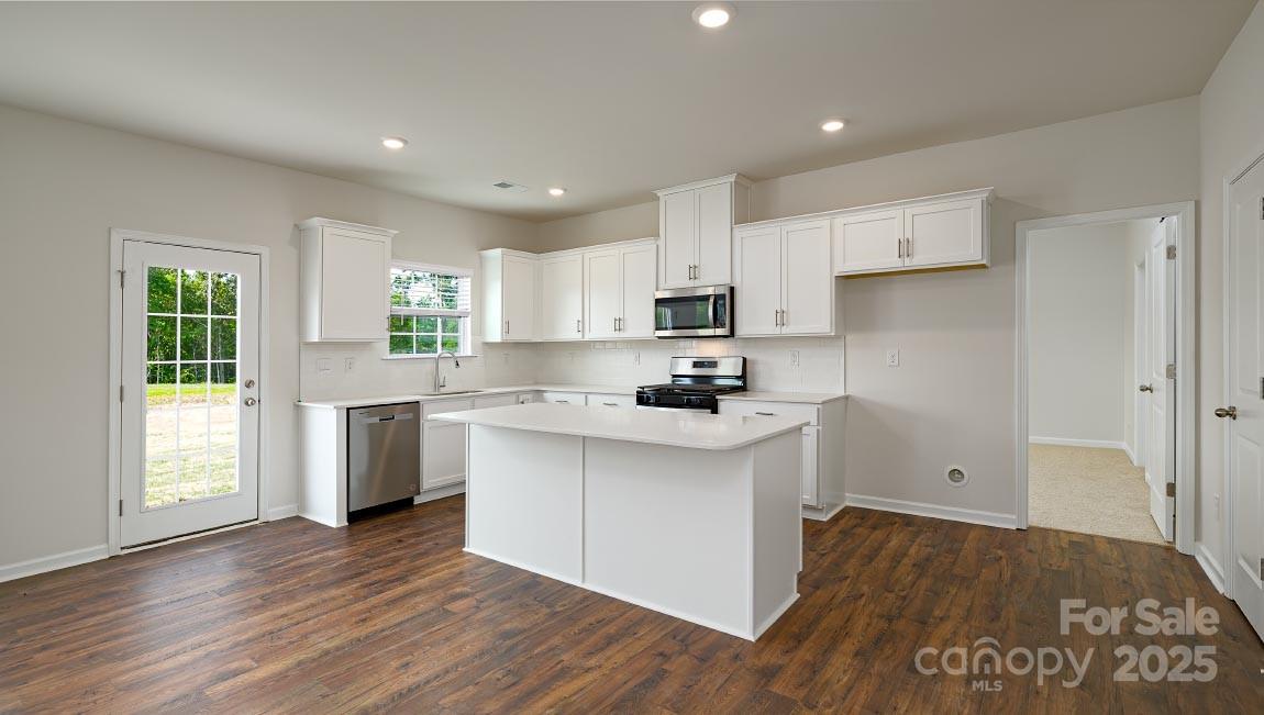 269 Shorthorn Road Fletcher, NC 28732 - Photo 5 of 23 a kitchen with white cabinets and wooden floor