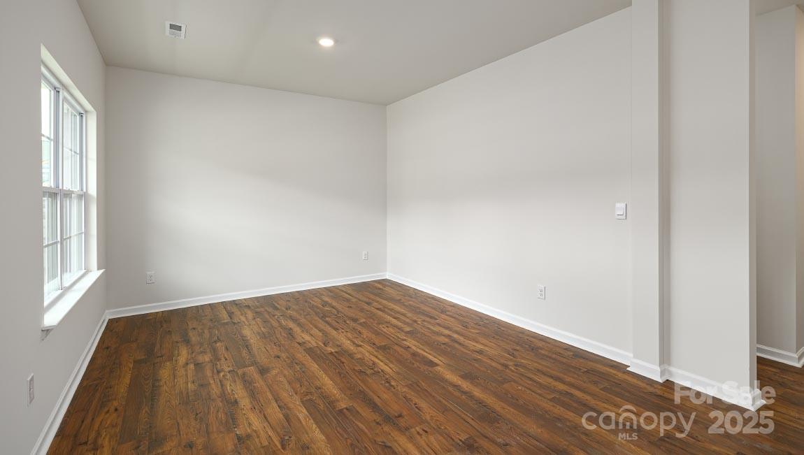 269 Shorthorn Road Fletcher, NC 28732 - Photo 7 of 23 an empty room with wooden floor and windows