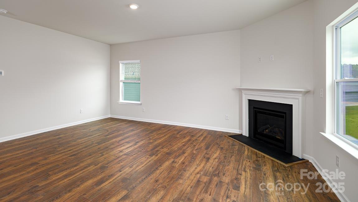 269 Shorthorn Road Fletcher, NC 28732 - Photo 8 of 23 wooden floor fireplace and windows in an empty room