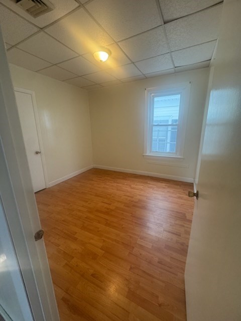 365 Lindsey Street, Unit 2 Fall River, MA 02720 - Photo 3 of 9 an empty room with wooden floor and windows