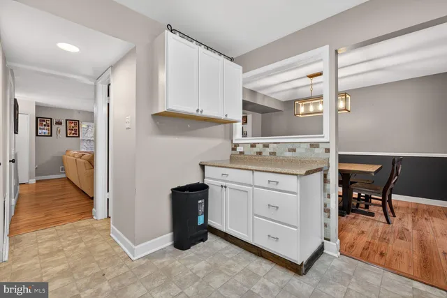 a kitchen with cabinets appliances and a dining table
