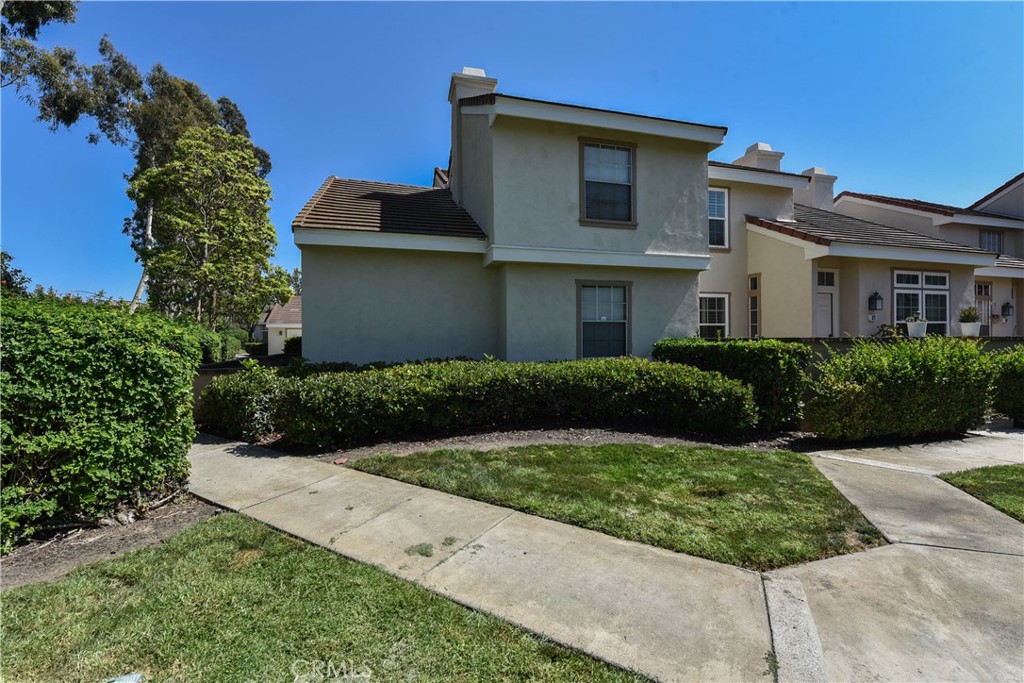 55 Wellesley, Unit 55 Irvine, CA 92612 - Photo 3 of 11 a front view of a house with a yard
