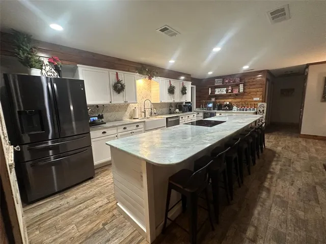 a large kitchen with a table and chairs