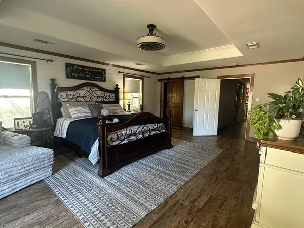 a bedroom with a large bed and a large window