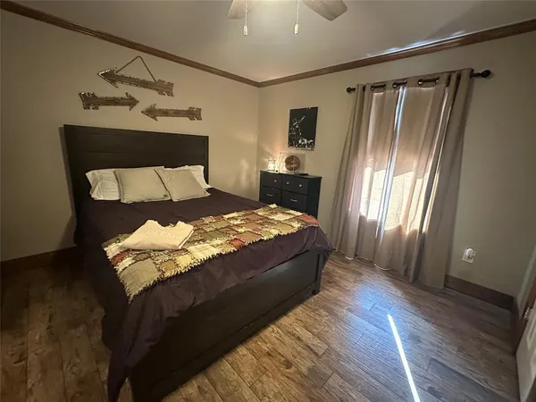 a bedroom with bed dresser and a chandelier