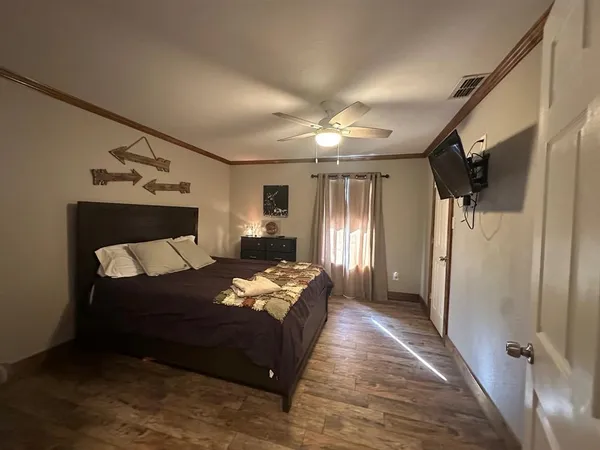 a bedroom with bed and window