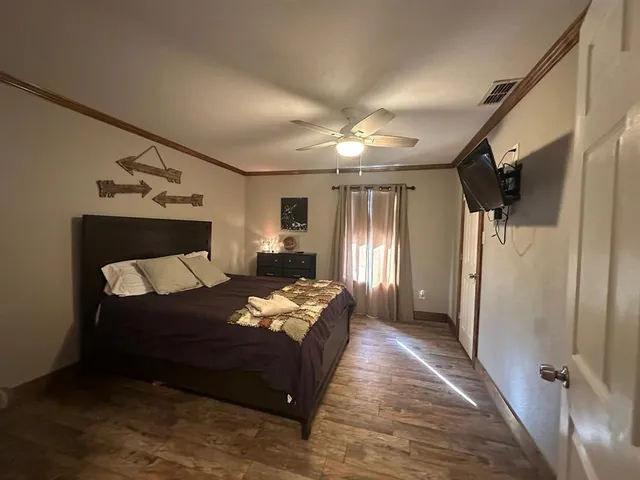 a bedroom with bed and window