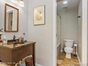 201 Shore Road Greenwich, CT 06830 - Photo 10 of 29 a bathroom with a toilet sink and mirror