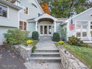 201 Shore Road Greenwich, CT 06830 - Photo 2 of 29 a front view of a house with a garden