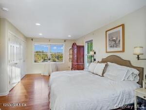 201 Shore Road Greenwich, CT 06830 - Photo 21 of 29 a bedroom with a large bed and a view of kitchen