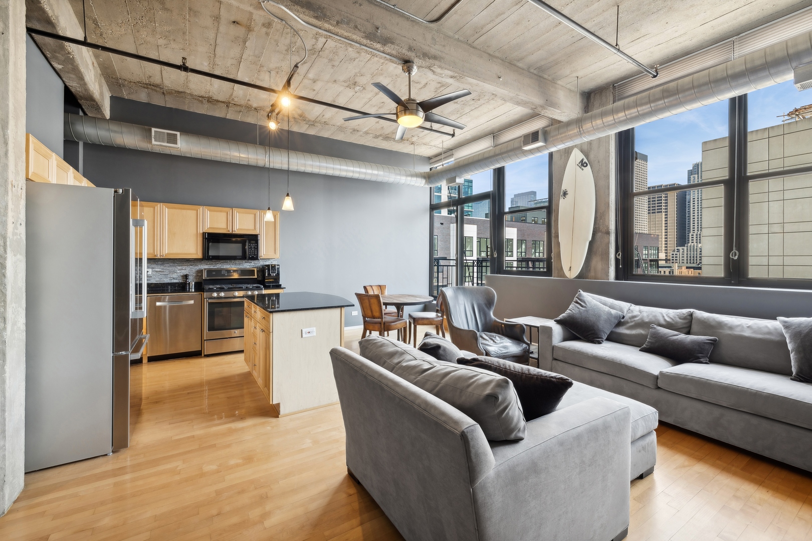 843 West Adams Street, Unit 606 Chicago, IL 60607 - Photo 6 of 12 a living room with furniture and a open kitchen view