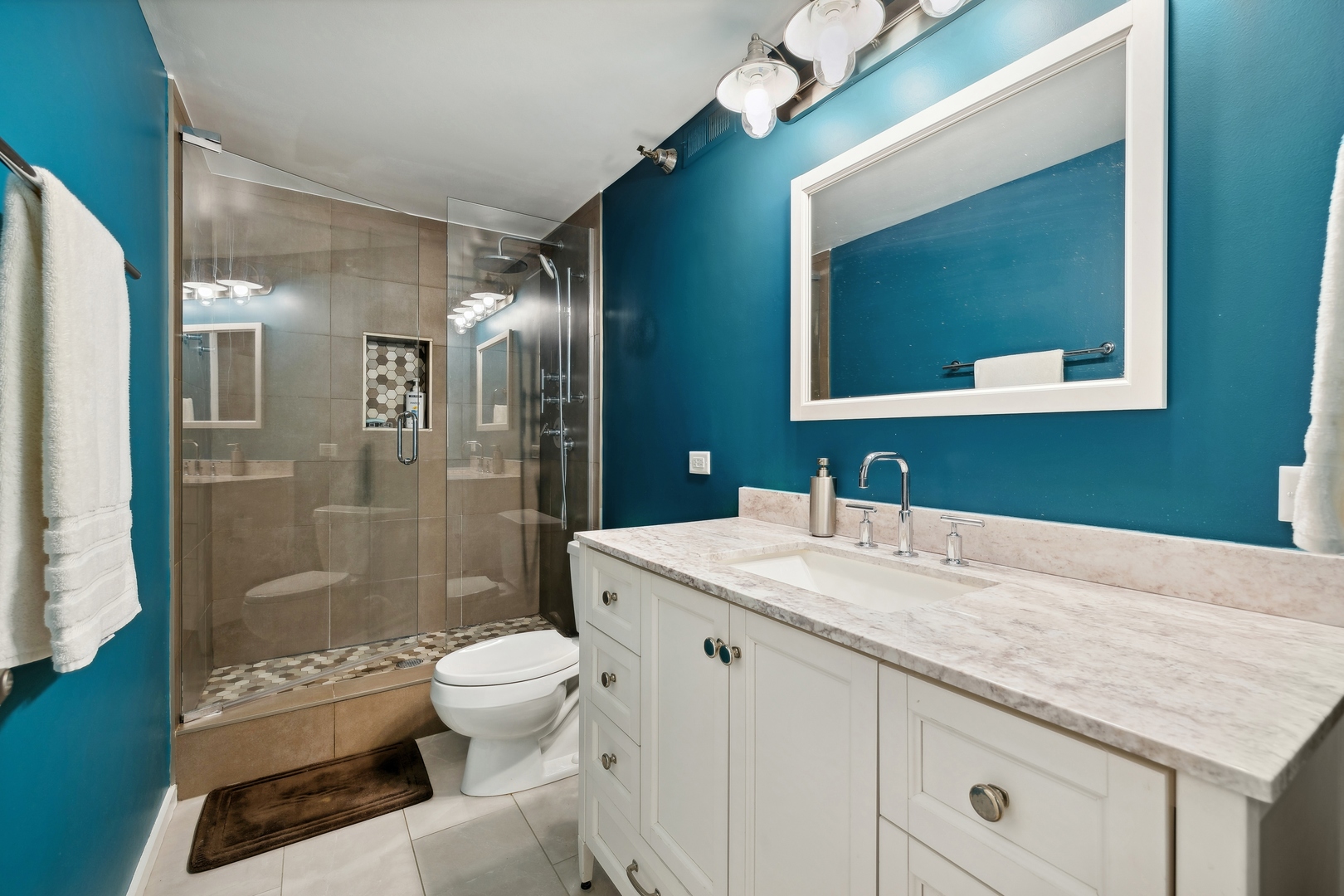843 West Adams Street, Unit 606 Chicago, IL 60607 - Photo 9 of 12 a bathroom with a granite countertop sink toilet a mirror and shower