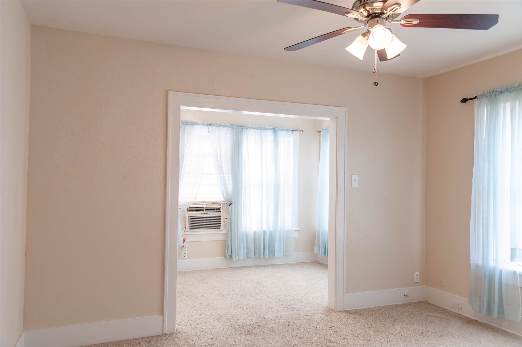 405 West Clay Street, Unit 1 Houston, TX 77019 - Photo 12 of 22 an empty room with a window and a ceiling fan