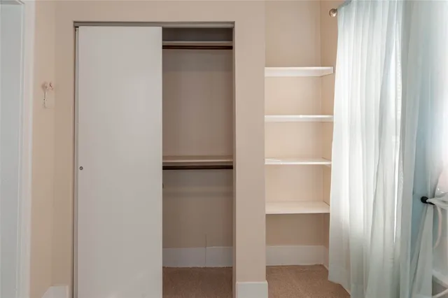 a white toilet sitting next to a shower curtain