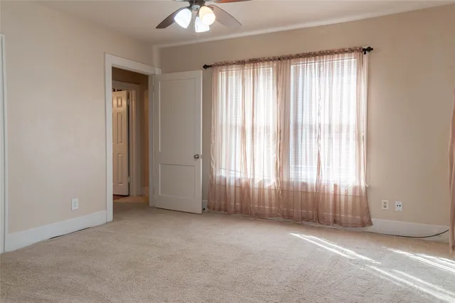 an empty room with windows and closet