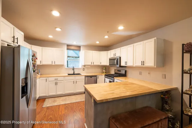 a kitchen with refrigerator and cabinets