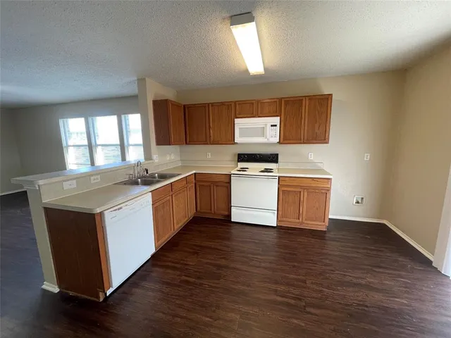 a kitchen with a stove top oven sink and window