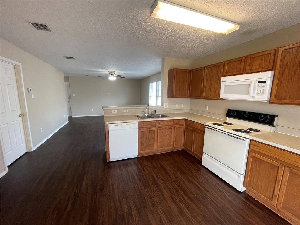 1123 Single Tree Drive Forney, TX 75126 - Photo 5 of 10 a kitchen with a sink cabinets stainless steel appliances and a window