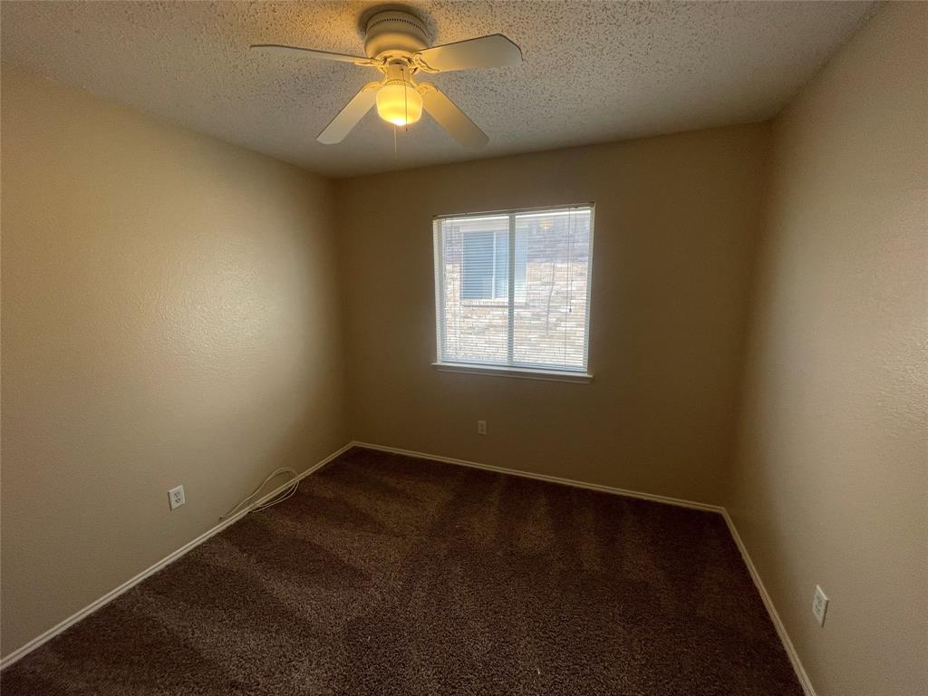 1123 Single Tree Drive Forney, TX 75126 - Photo 8 of 10 an empty room with a window and chandelier fan
