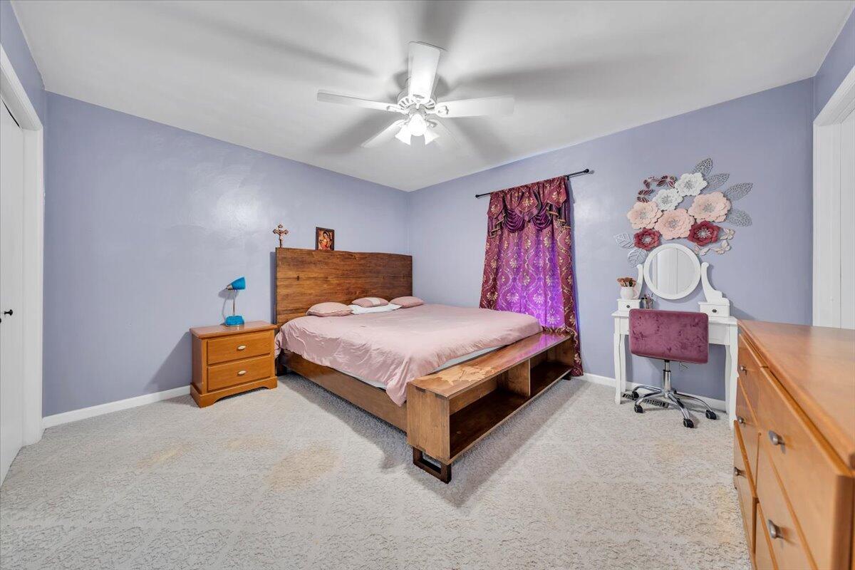 4751 Westvale Road Northeast Roanoke, VA 24019 - Photo 14 of 30 a bedroom with a bed and a chandelier