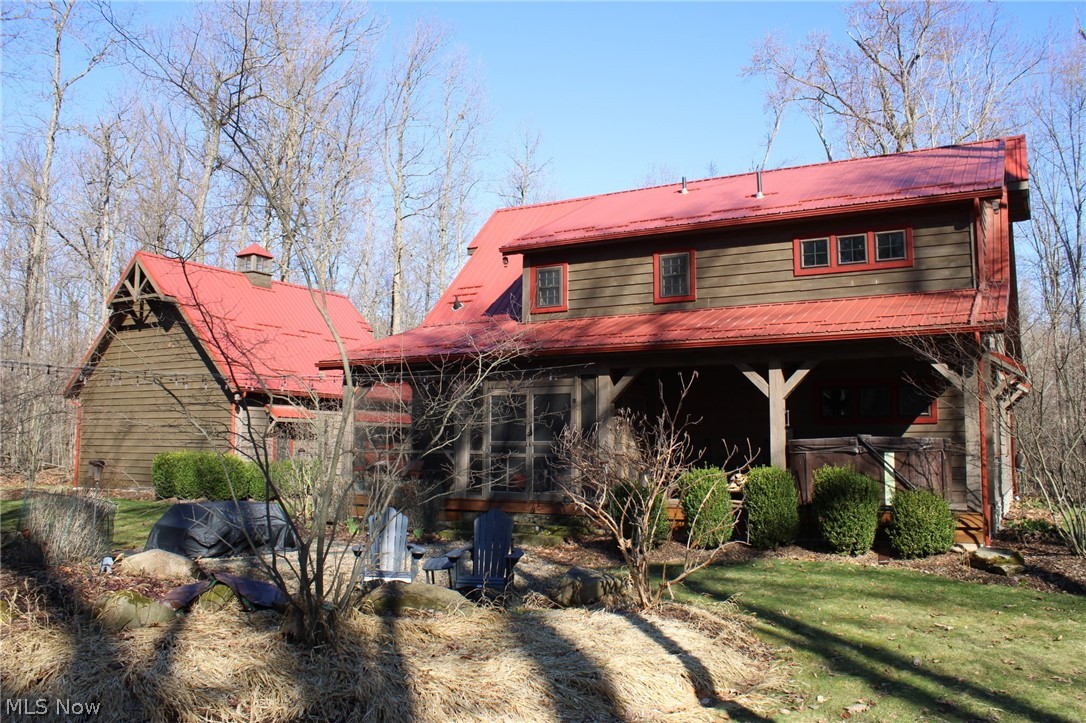 3989 Court Road Wakeman, OH 44889 - Photo 28 of 36 Rear view of house with a metal roof and a yard