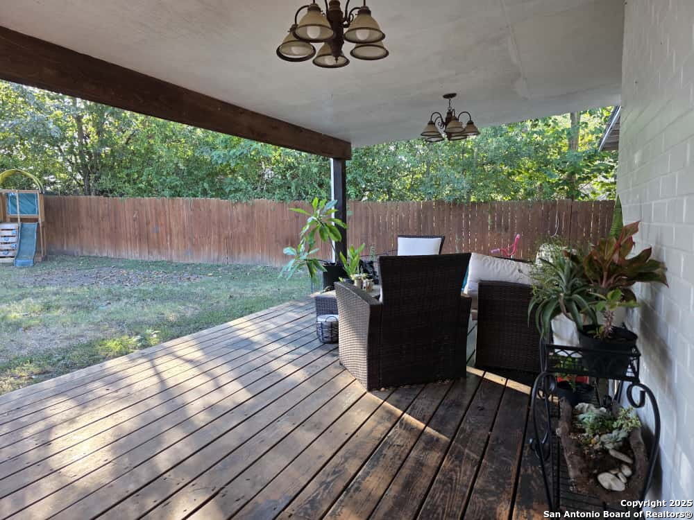 a view of a patio with table and chairs potted plants with wooden floor