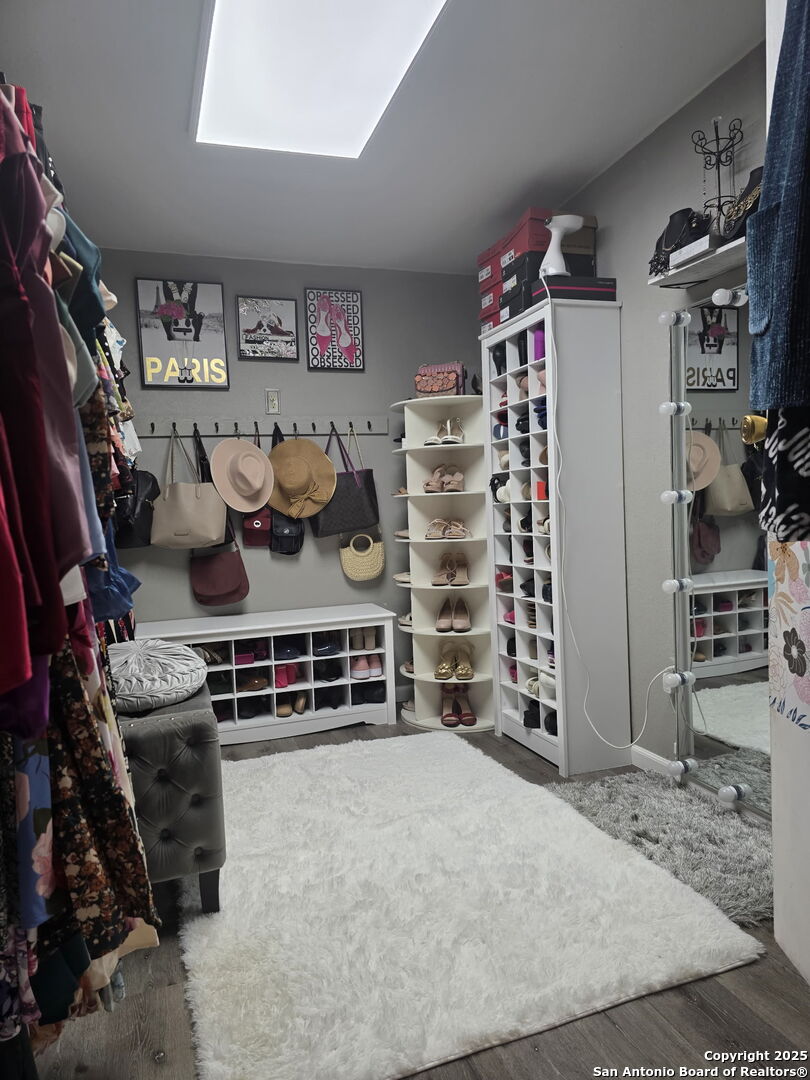 932 South Getty Street Uvalde, TX 78801 - Photo 12 of 17 a view of walk in closet with clothes and shoes