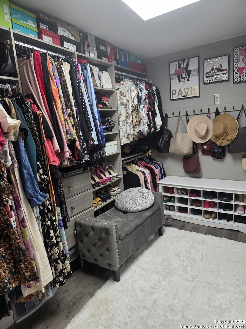 932 South Getty Street Uvalde, TX 78801 - Photo 13 of 17 a view of walk in closet with clothes and shoes