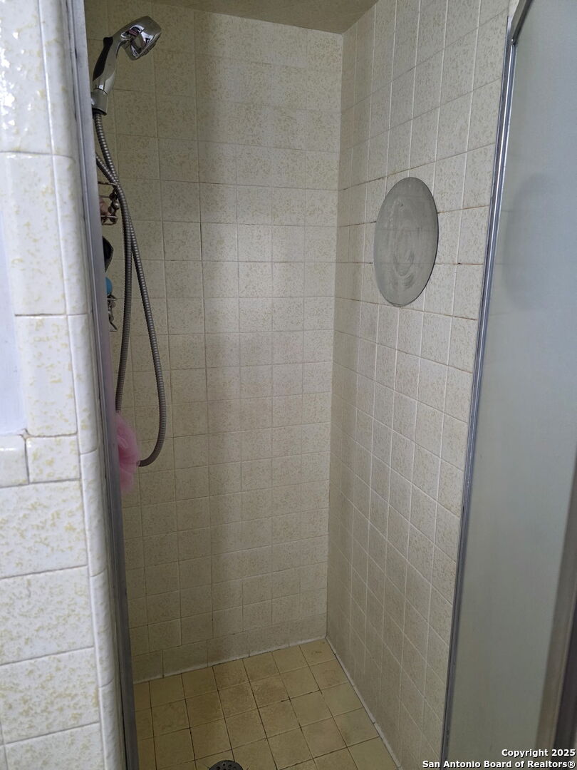 932 South Getty Street Uvalde, TX 78801 - Photo 14 of 17 a bathroom with a shower