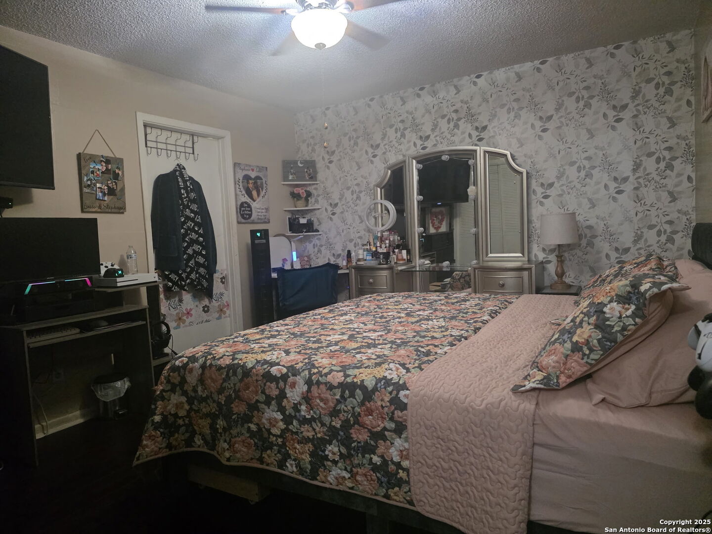 932 South Getty Street Uvalde, TX 78801 - Photo 10 of 17 a bedroom with a bed dresser and a flat tv screen